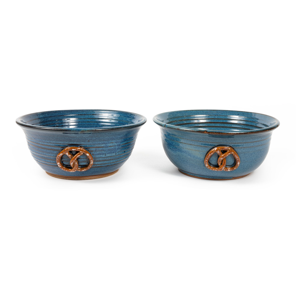 Two blue ceramic bowl decorated with a pretzel design.
