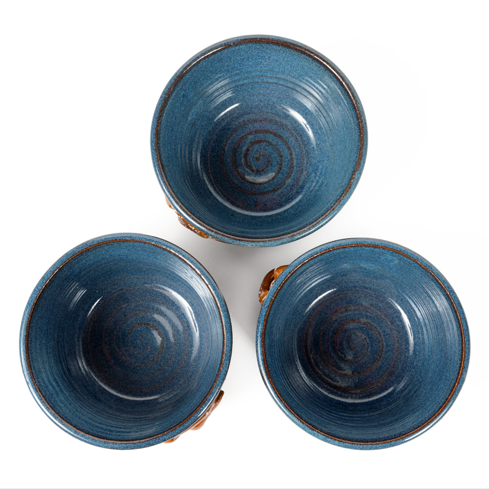 Top image of three blue ceramic bowls decorated with a pretzel designs.